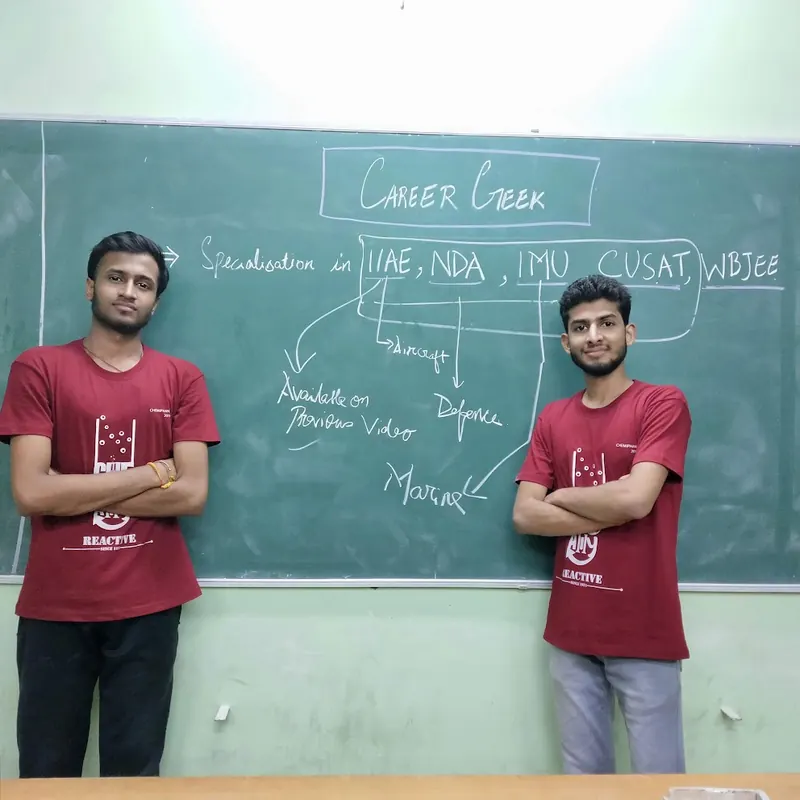 Bunny Goyal and his co-founder in front of a blackboard headed Career Geek, listing the exams they specialised in