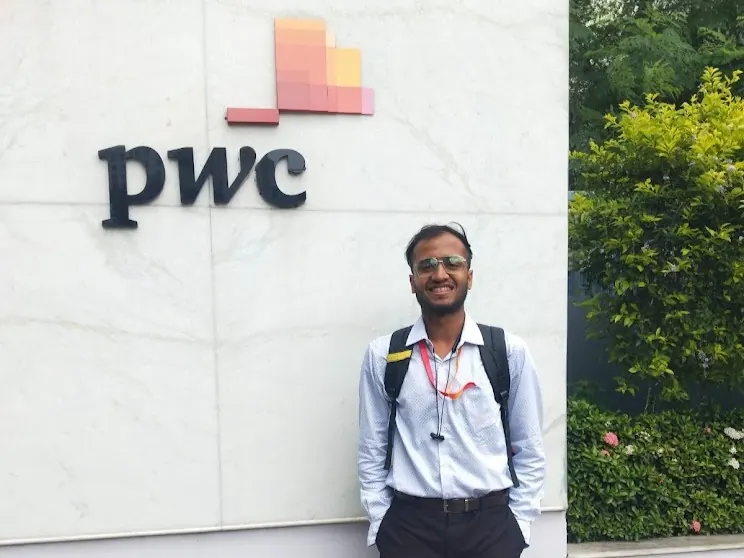 Bunny Goyal outside the PwC India office, beside the PwC sign